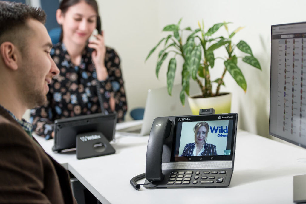Coworkers talking on a video conference call using SuperVision platform by Wildix