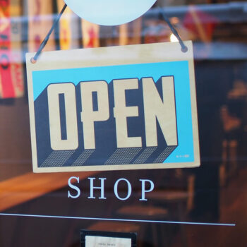 Small retail business with an “open” sign on door